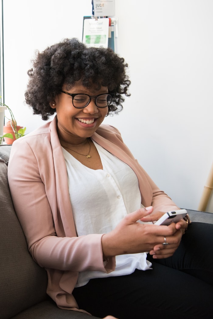 Young professional reviewing her finances on her phone